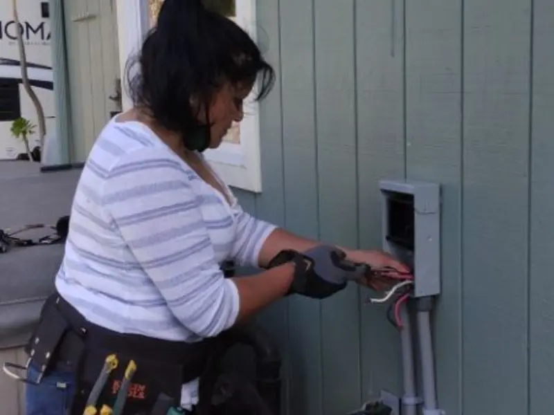 Licensed electrician wiring an exterior subpanel in Landmark